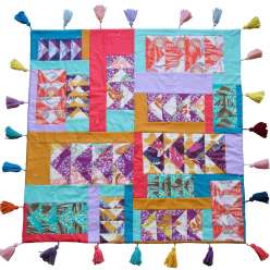 Anna Maria Horner puts a fresh spin on the traditional Flying Geese design with this baby quilt. She explains how she chooses solid and prints, lights and darks, and how she pairs different prints to add depth and pop to each block. 
