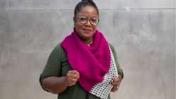 Tian Connaughton wearing a hand-crocheted pink and grey shawl from her Design Your Own Crochet Shawl Creativebug class.