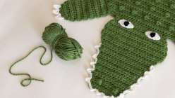 A green crocheted alligator rug  made in Twinkie Chan's Crochet a Wild Animal Rug class on Creativebug