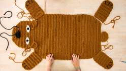 A brown-colored crochet rug in the shape of a bear being assembled in Twinkie Chan's Crochet a Wild Animal Rug class on Creativebug