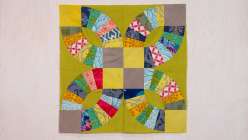An image of Sarah Bond's Pickle Dish quilt block in chartreuse, taupe, yellow and multicolored cotton fabrics.