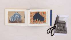 An overhead image of an open book with a blue and white cut out house on the left hand page and a black house on the right hand page, taken from Creativebug's Altered Books Daily Practice class