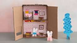 An image of the inside of a doll house made out of cardboard from Suzy Williams's Sustainable Play: Make a Dollhouse Cafe class on Creativebug