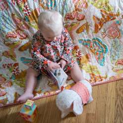 Anna Maria Horner teaches you the entire process of creating a baby quilt, from laying out and basting, then highlighting the design of a printed fabric with even stitching, and finally binding the quilt with single fold bias binding.