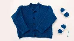 A blue crocheted sweater made by Tian Connaughton in her Crochet the Harrison Sweater class on Creativebug