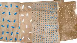 A selection of brown papers painted with blue and white paint in Suzy Altman's Crafting Together: Sustainable Wrapping Paper class on Creativebug