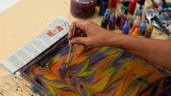 A hand making git gel stripes in Mercedez Rex's Creativity Through Marbling daily practice class on Creativebug