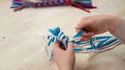 A braided toy being made in Faith Hale's Make an Eco-Friendly Dog Toy class on Creativebug