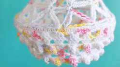 Detail of a white crocheted lantern made by Twinkie Chan in her Crochet Home Decor: Make Hanging Lanterns class on Creativebug.