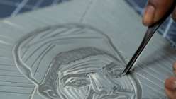 A linoleum block being carved by Sarah Matthews in her Carve and Print a Multi-Block Relief Portrait class on Creativebug.
