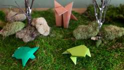 A folded paper fox, turtle, and frog made in Faith Hale's Origami Safari Daily Practice class on Creativebug