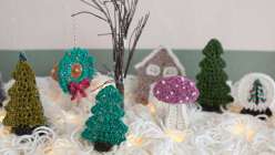 A crocheted wreath, a crocheted mushroom, and a crocheted evergreen tree made by Twinkie Chan in her Holiday Crochet Applique class on Creativebug