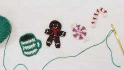 A crocheted mug, a crocheted gingerbread person, and crocheted candy made by Twinkie Chan in her Holiday Crochet Applique class on Creativebug