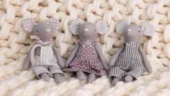 Three tiny gray sewn mice dolls made in Katia Ferris's Sew a a Mouse Doll class on Creativebug 