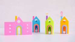 Three colorful paper lanterns with battery tea lights and one paper template made by Dawn M. Cardona for her Paper Lantern class on Creativebug. 