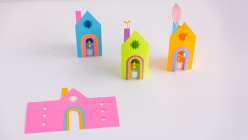 Three colorful paper lanterns with battery tea lights and one paper template made by Dawn M. Cardona for her Paper Lantern class on Creativebug. 