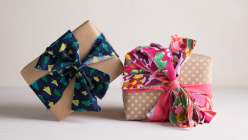 Two gifts wrapped in brown paper and tied with scrappy fabric bows from the Creativebug mixtape class The Night Before Christmas.