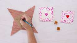 Three completed Valentine's Day-themed folded Victorian puzzle purses made in Courtney Cerruti's Make a Victorian Puzzle Purse class on Creativebug.