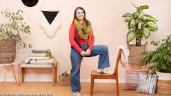 Liza Laird demonstrating a chair yoga technique in her Creativebug Live class Mindful Movement for Makers.