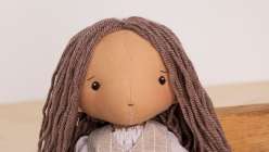 A rag doll with long yarn hair made in Katia Ferris's Creativebug class Rag Doll Hairstyles: Short and Long.