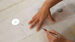 A pair of hands drafting a pair of leggings in Sanae Ishida's Creativebug class Draft and Sew a Pair of Leggings on Creativebug.