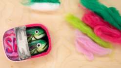 A felted tin of sardines made by Risa Iwisaki Culbertson in her Creativebug class Needle Felting: Three Techniques for Sculpting Tinned Fish.