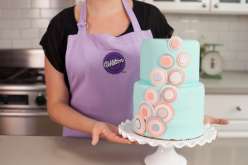 Emily Tatak of Wilton teaches how to use fondant to create a smooth finish on a stunning tiered cake in this baking and cake decorating class.  Come decorate cakes with color fondant to cover a two-tiered stacked cake.
