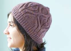 Designer Norah Gaughan shows you how to make this gloriously textured cabled hat.  You'll learn to work with worsted weight yarn, as the hat is made with a ribbed cable cast on, repeating cable pattern, and sinuous curves.