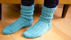 Learn how to make beautifully textured socks featuring a twisted rib stitch with expert crafter Edie Eckman.