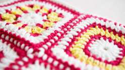 Over the course of four weeks, learn how to make this cheerful baby blanket alongside crochet expert Edie Eckman. Two easy crochet squares are repeated over and over to create the design, and the entire blanket can be made with just three skeins of yarn. 