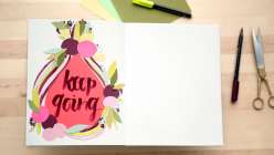 Learn how to make a mixed media collage in your sketchbook. Pam Garrison will also show you how to do hand lettering using brush-tip markers.