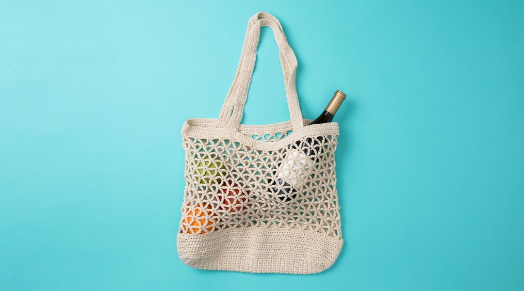 Knitted String Bag Weighs On A Vintage Brick Wall Stock Photo